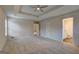Spacious main bedroom with neutral carpet, walls, and view into attached bathroom at 221 Ashley Oaks Dr, Mcdonough, GA 30253