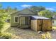 Exterior view of a home with a porch and fenced yard, surrounded by greenery at 5166 Avery Sw St, Covington, GA 30014