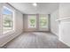 Bright bedroom featuring neutral walls, plush gray carpeting, and natural light at 5166 Avery Sw St, Covington, GA 30014