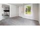 Cozy bedroom with plush gray carpeting, neutral walls, and a bright window at 5166 Avery Sw St, Covington, GA 30014