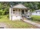 Charming cottage-style home with a welcoming front porch and landscaped yard at 5166 Avery Sw St, Covington, GA 30014