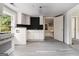 Bright kitchen featuring white cabinetry, gray flooring, and ample counter space at 5166 Avery Sw St, Covington, GA 30014