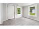 Bright living room with two windows and a light grey carpet at 5166 Avery Sw St, Covington, GA 30014
