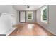 Sunlit living room with fireplace, hardwood floors, and large windows at 5166 Avery Sw St, Covington, GA 30014