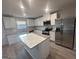 Beautiful kitchen with a spacious island, granite countertops, and stainless steel appliances at 11045 Shadow Creek Ter # 65, Hampton, GA 30228