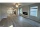 Bright and open living room with hardwood floors and an electric fireplace at 11045 Shadow Creek Ter # 65, Hampton, GA 30228