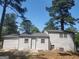 The house has a white exterior and a backyard with scattered leaves and tall green trees at 2615 Old South Ct, Jonesboro, GA 30236