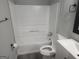Updated bathroom with sleek white fixtures, including a tub and vanity, and modern accents at 2615 Old South Ct, Jonesboro, GA 30236