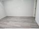 Bedroom featuring neutral decor, new flooring, and natural light from a large window at 2615 Old South Ct, Jonesboro, GA 30236
