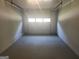 This garage has an empty concrete floor with white walls and a white door at 2615 Old South Ct, Jonesboro, GA 30236