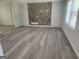 Bright living room featuring new flooring and a unique stone accent wall at 2615 Old South Ct, Jonesboro, GA 30236