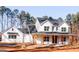 Charming farmhouse style home with a welcoming front porch and classic white siding at 253 E Crestwood Rd, Tyrone, GA 30290