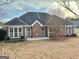 Rear exterior of a brick home featuring large windows providing ample natural light at 410 Oakpark Ter, Mcdonough, GA 30253