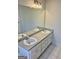 Well-lit bathroom featuring a double sink vanity with clean white cabinets at 410 Oakpark Ter, Mcdonough, GA 30253