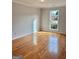 A bright bedroom features gleaming hardwood floors and a window providing ample natural light at 410 Oakpark Ter, Mcdonough, GA 30253