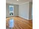 Bedroom boasts sleek hardwood floors and a window view, blending modern style with cozy comfort at 410 Oakpark Ter, Mcdonough, GA 30253