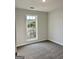 Cozy bedroom featuring a window offering natural light and plush carpeting for comfort at 410 Oakpark Ter, Mcdonough, GA 30253