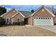 A well-maintained brick home with an attached two-car garage and inviting entrance at 410 Oakpark Ter, Mcdonough, GA 30253