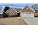 Charming brick home with a well-manicured front yard and attached two-car garage at 410 Oakpark Ter, Mcdonough, GA 30253