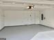 Clean, finished garage with epoxy flooring and ample storage space at 410 Oakpark Ter, Mcdonough, GA 30253