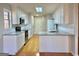 Spacious kitchen with white cabinets, granite countertops, and hardwood floors at 410 Oakpark Ter, Mcdonough, GA 30253