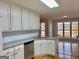 Updated kitchen with granite countertops, stainless steel dishwasher and white cabinetry at 410 Oakpark Ter, Mcdonough, GA 30253