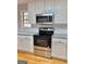Modern kitchen featuring stainless steel appliances and granite countertops at 410 Oakpark Ter, Mcdonough, GA 30253
