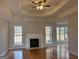 Living room with a fireplace, hardwood floors, windows, and a ceiling fan, offering a cozy and inviting space at 410 Oakpark Ter, Mcdonough, GA 30253