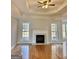 Living room with a decorative fireplace, hardwood floors, and windows showcasing the home's design and comfort at 410 Oakpark Ter, Mcdonough, GA 30253
