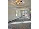 The main bedroom boasts a tray ceiling, ceiling fan, and windows, creating a light-filled, relaxing space at 410 Oakpark Ter, Mcdonough, GA 30253