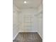 Spacious walk-in closet with carpeted floor and metal shelving for optimal storage and organization at 410 Oakpark Ter, Mcdonough, GA 30253