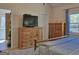Bedroom with wooden furniture, a television, and a view to the exterior at 809 Mcbean Ct, Mcdonough, GA 30252