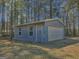 Detached outbuilding with a garage door and windows, providing extra storage and workspace at 809 Mcbean Ct, Mcdonough, GA 30252