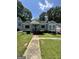 Charming single-story home with a walkway, manicured lawn, and mature trees at 1730 Emerald Sw Ave, Atlanta, GA 30310
