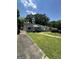 Street view of the home, showing the expansive front lawn and nearby homes at 1730 Emerald Sw Ave, Atlanta, GA 30310