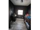 Cozy bedroom with dark walls, light wood floors and a small window to allow natural light to come in at 1132 Se Oak Knoll Ter, Atlanta, GA 30315