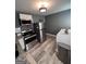 This modern laundry room features stainless steel appliances and stylish, gray walls at 1132 Se Oak Knoll Ter, Atlanta, GA 30315