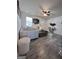 Bright living room with contemporary decor, featuring a comfortable white sofa and gray wood floors at 1132 Se Oak Knoll Ter, Atlanta, GA 30315