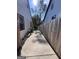 Home's side yard features a concrete path between the houses with a lawn mower at 1132 Se Oak Knoll Ter, Atlanta, GA 30315