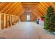 Spacious unfinished attic with exposed wood beams, a ceiling fan, and a window at 4128 Hunt Sw St, Covington, GA 30014