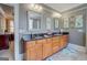 Bathroom featuring double sinks with granite countertops, framed mirrors, and decorative accents at 4128 Hunt Sw St, Covington, GA 30014