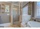 Bathroom featuring a luxurious soaking tub, tiled shower, and frosted windows, offering a spa-like retreat at 4128 Hunt Sw St, Covington, GA 30014