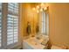 Bright bathroom featuring white fixtures, shuttered window, and decorative accents at 4128 Hunt Sw St, Covington, GA 30014