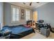 Bedroom with a bed, desk, ceiling fan, carpet, and lots of natural light from the two windows at 4128 Hunt Sw St, Covington, GA 30014