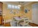 Cozy dining area featuring a wooden table, stylish chairs, natural light, and charming decor at 4128 Hunt Sw St, Covington, GA 30014
