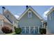 Attached garage with decorative doors and lush landscaping surrounding the property at 4128 Hunt Sw St, Covington, GA 30014