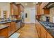 Well-appointed kitchen with stainless steel appliances, granite countertops, wooden cabinets, and hardwood flooring at 4128 Hunt Sw St, Covington, GA 30014