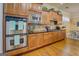 Warm kitchen featuring stainless steel appliances, wood cabinets, and granite countertops at 4128 Hunt Sw St, Covington, GA 30014