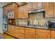 Stylish kitchen featuring granite countertops, custom cabinets, and a gas range with stainless steel appliances at 4128 Hunt Sw St, Covington, GA 30014