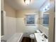 Clean bathroom features a tub and shower combo, with updated vanity and fixtures at 1901 Clarke Ln, Decatur, GA 30035